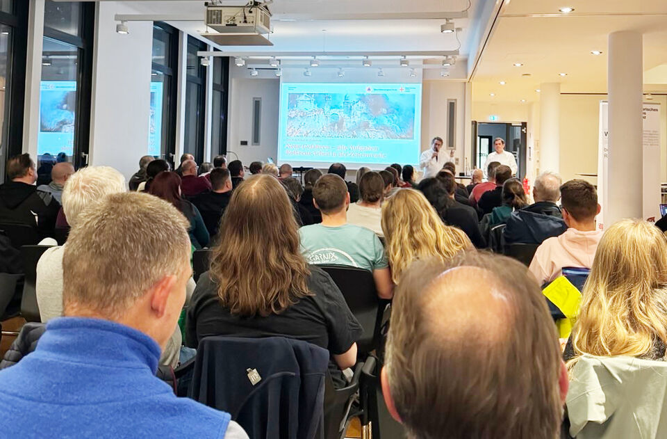 P5-Fortbildung 1 Menschen in Sitzreihen mit Blick auf eine Leinwand